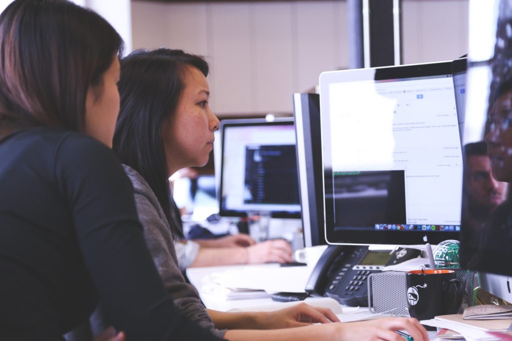 Two women working at computer screens.